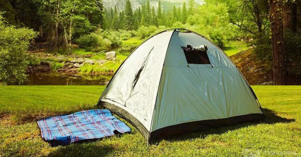 a-campfire-on-grassland-in-front-of-a-camp