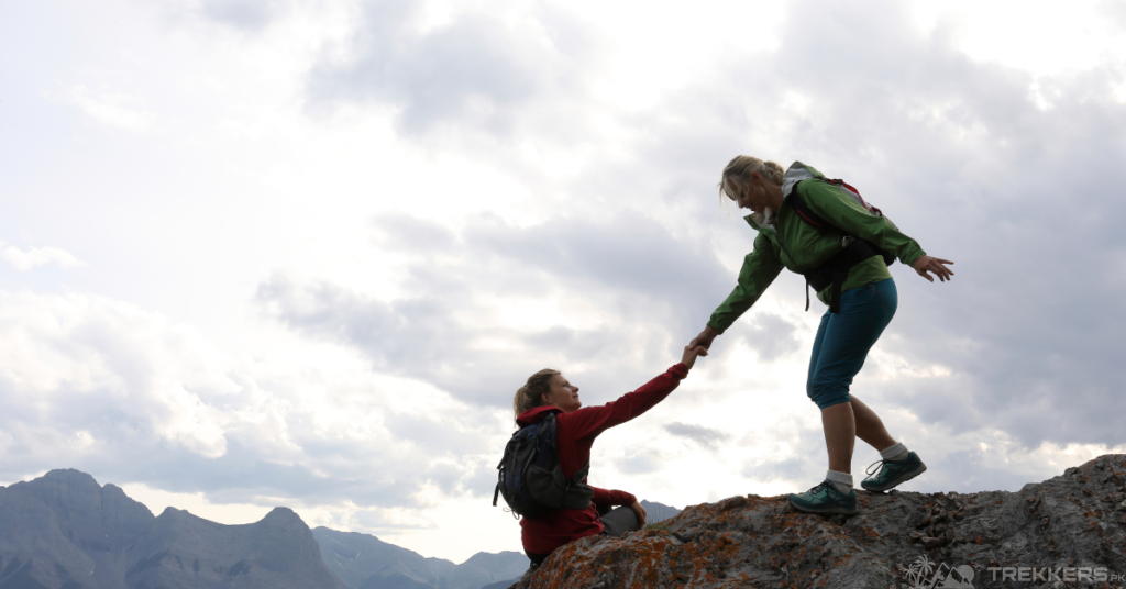 a-female-climber-giving-a-helping-hand-to-other-female