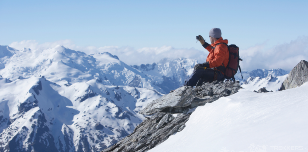 a-man-sitting-at-top-of-mountain-capturing-the-view