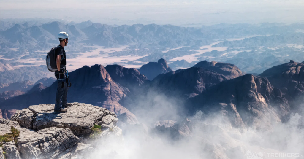 a-mountaineer-standing-at-the-top-of-rock