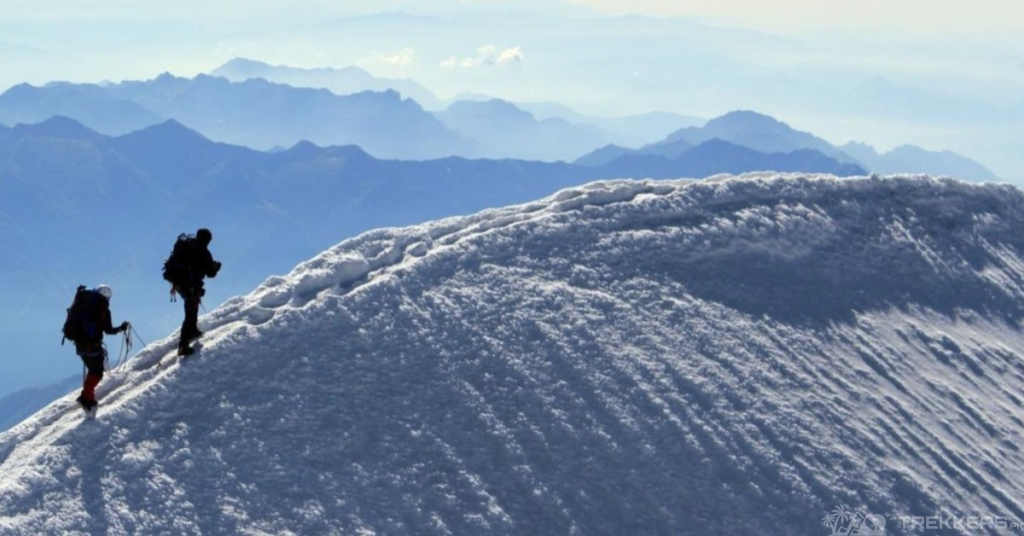 two-mountaineers-summiting-a-peak