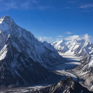 High-altitude photograph of K2 and surrounding jagged peaks and glaciers within the Karakoram mountain range of Pakistan. Mountain Range Peaks