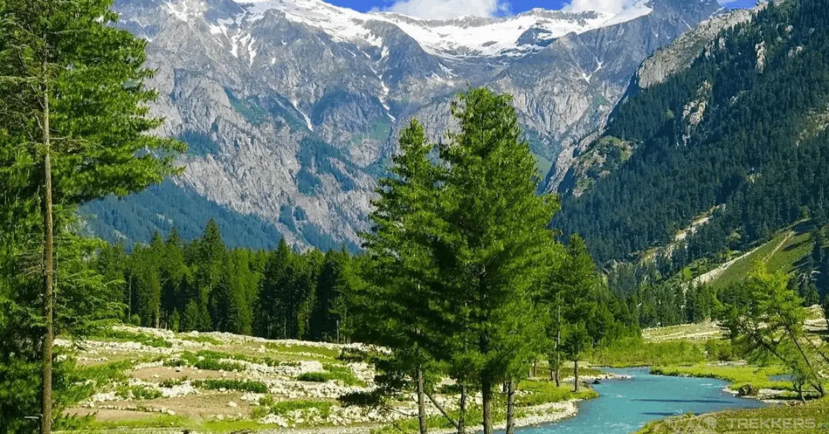Panoramic view of the Panjkora River flowing through Kumrat Valley with snow-capped mountain peaks in Upper Dir District, Pakistan.