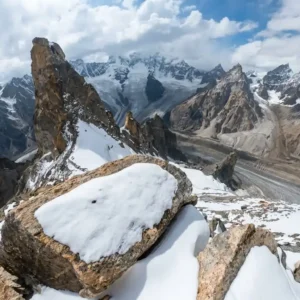 Wide panorama from the summit ridge of Laila Peak at 6,096 meters elevation showing snow-covered Karakoram mountains and Hushe Valley glaciers.