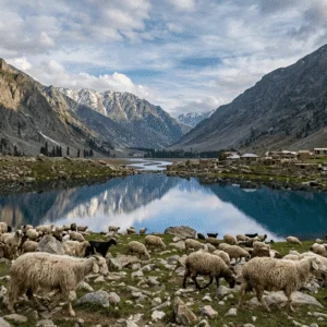 Breathtaking scenic view capturing the natural beauty of Swat Valley Pakistan, showcasing a crystal-clear lake surrounded by traditional village houses, green mountains, and sheep grazing on the rocky meadows. High-quality Swat images for travel guides.