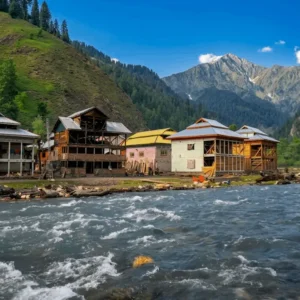 Wooden traditional houses along rushing blue river stream in Azad Kashmir Neelum Valley