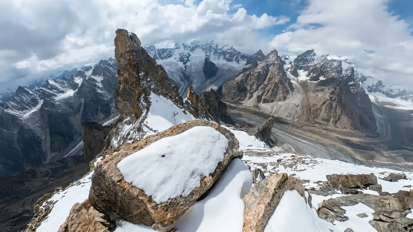 Wide panorama from the summit ridge of Laila Peak at 6,096 meters elevation showing snow-covered Karakoram mountains and Hushe Valley glaciers.